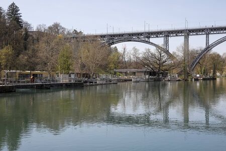 Bern, Switzerland - April 18, 2019: There is a huge steel bridge over the river. The Aare River...