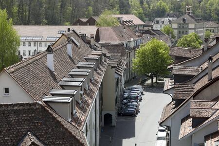 Bern, Switzerland - April 23, 2019: Tenement houses, whose roofs covered with ceramic tiles can be...