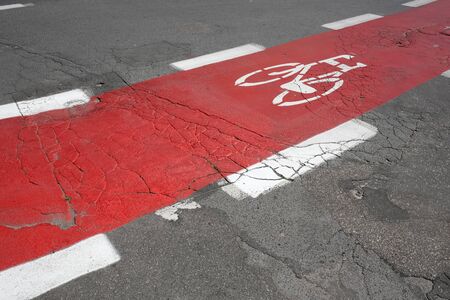 The bicycle lane was painted red and the bicycle symbol was painted there. This is a part of the street in Kolobrzeg in Poland.の写真素材