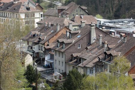 Bern, Switzerland - April 16, 2018: There are town houses with their slanted roofs covered with ceramic tiles. This is an example of dense urban development.のeditorial素材