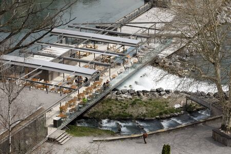 Bern, Switzerland - April 16, 2018: There is a small weir on the river and just nearby there is a...
