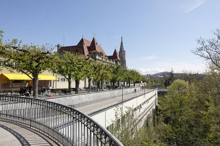 Bern, Switzerland - April 18, 2019: Historical buildings are somewhat obscured by trees. In the...