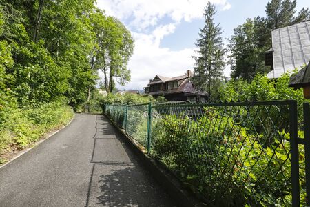 Zakopane, Poland - July 11, 2019: There is a peaceful street and residential houses. Many trees and plants are also hereのeditorial素材