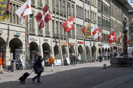 Bern, Switzerland - April 17, 2019: The street where the buildings have been decorated with flags....