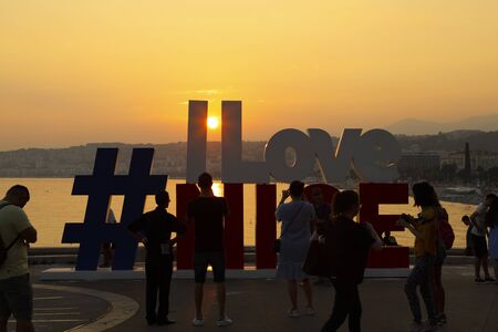 Nice, France - 20 September 2018: There is a text I Love Nice, which you can see at sunset, and there are people around. The text starts with the hashtag sign.のeditorial素材