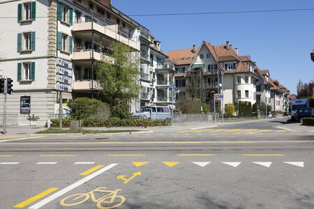 Bern, Switzerland - April 20, 2019: The houses in a friendly neighborhood. Slightly outside the city center are residential houses surrounded by trees and plants and the streets are rather low trafficのeditorial素材