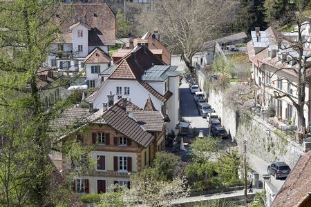 Bern, Switzerland - April 18, 2019: A narrow street and residential houses on both sides of it....