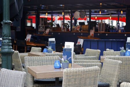 The Hague, The Netherlands - October 07, 2019: Empty tables and chairs of the outdoor restaurant were placed on the pavement in the city.のeditorial素材
