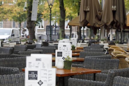 The Hague, The Netherlands - October 07, 2019: Many tables and chairs have been placed on the sidewalk in the city.のeditorial素材