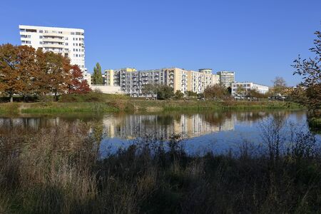 Warsaw, Poland - October 20, 2019: There is the lake an a park. A multi-family housing estate at a distance can be seen. It is part of one of the residential districts in the city.のeditorial素材