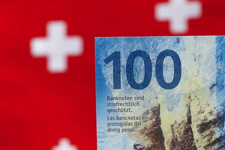 A hundred Swiss francs banknote, and the flag symbols are visible in the background. This is the eighth series of Swiss banknotes that were put into circulation between 2016 and 2019.の写真素材