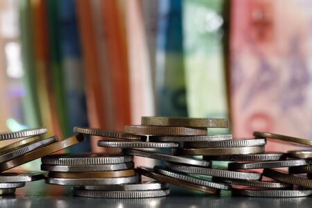 There are coins on the background of the notes seen in the distance. These coins are carelessly...
