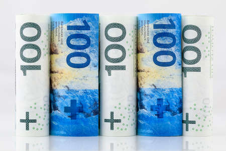 Rolls of Polish banknotes and rolls of Swiss currency. Such a vicinity expresses the relationship between the Swiss francs and the Polish zloty. PLN and CHF currency.の写真素材