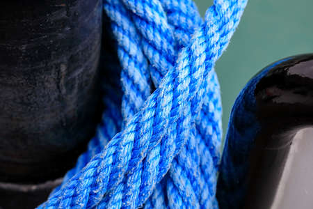 The mooring bollard on which the blue rope is visible.の写真素材