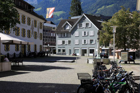 Altdorf, Switzerland - August 27, 2020: There are houses situated on small square. Bike parking and fountain are on the town square as well.のeditorial素材