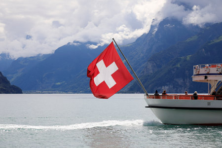 Lake Lucerne, Switzerland - August 31, 2020: The motor ship sails away and you can see this on Lake Lucerne. The mountains are visible in the distance.のeditorial素材