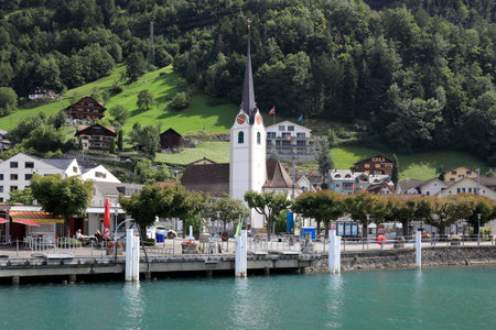 Fluelen, Switzerland - August 25, 2020: The church with belfry is nicely situated in a green...
