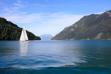 Brunnen, Switzerland - August 25, 2020: A sailboat sails on the large lake Lucerne. The place is a...