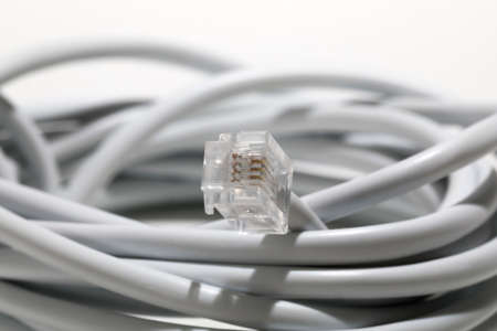 Telephone network cord with 4-pin plug. The symbol of this connector is rj11.の写真素材