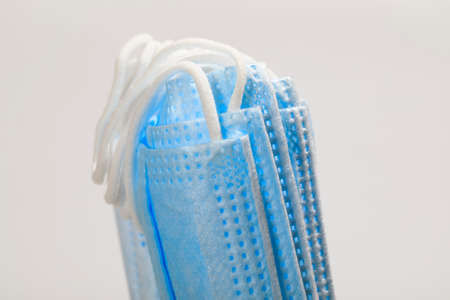 Group of medical masks equipped with ear loops. Due to the aggressive virus, , the use of prophylaxis in the form of face masks is one of the protective methods.の写真素材