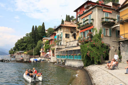 Varenna, Italy - July 12, 2009: Buildings right on Lake Como. There are boats, small pier and people enjoying good weather.のeditorial素材