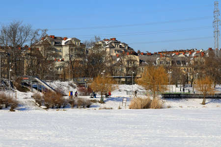 Warsaw, Poland - February 18, 2021: Apartment buildings in a district of Warsaw, locally known as Goclaw. These residential buildings can be seen near the frozen lake on a sunny winter day.のeditorial素材
