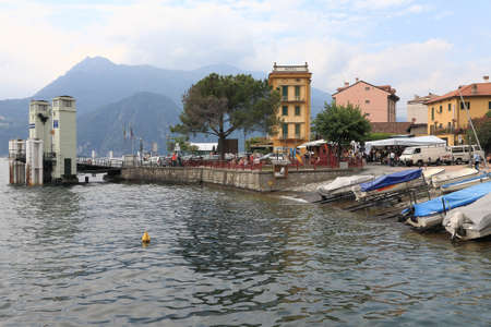 Varenna, Italy - July 12, 2009: Buildings on Lake Como. There are boats, ferry terminal and people enjoying good weather.のeditorial素材