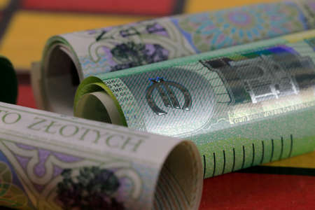 The Rolls of Polish paper money and the Euro express the relationship between Euro money and Polish zloty. PLN and EUR currencies placed on chessboard.の写真素材