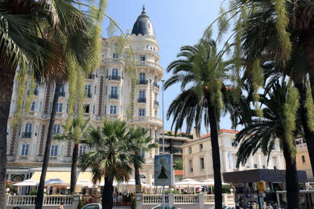 Cannes, France - July 05, 2009: The large building where the hotel is located is seen behind palm trees. Inter Continental Carlton is located in a prime point on the Boulevard de La Croisette.のeditorial素材