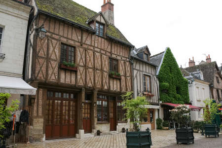 Amboise, France - June 09, 2010: A half-timbered houses are seen among other houses. Large pots of...