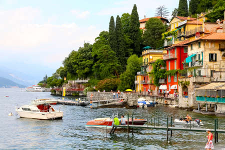 Varenna, Italy - July 12, 2009: Buildings right on Lake Como. There are boats, small pier and people enjoying good weather.のeditorial素材