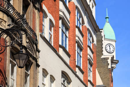 London, England - June 05, 2010: It is a fragment of an decorative facade of the building with a small tower, on which a clock is visible.のeditorial素材