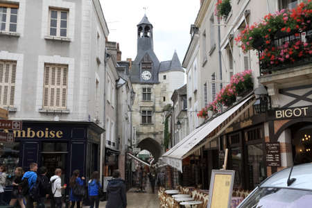 Amboise, France - June 09, 2010: Buildings of the town, where on the ground floor there are shops and cafes. There are also a few people walking along the sidewalk.のeditorial素材