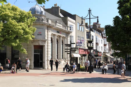 Worthing, United Kingdom - June 04, 2010: The architecture of this seaside town as seen along one of the streets where people can be spotted.のeditorial素材