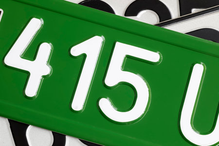 Vehicle license plates with numbers and letters on them. The different colors result not only from their country of origin but also from the purpose of the vehicle on which they are placed.の写真素材