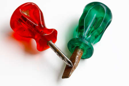 Two screwdrivers, one with red and one with green handle.