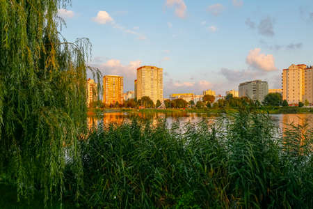 Warsaw, Poland - August 21, 2021: Buildings of flats where many families are housed in the Goclaw housing estate are illuminated at dusk by the colors of the slowly setting sun.のeditorial素材