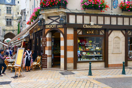 Amboise, France - June 09, 2010: A shop window with a corner entrance to the cafe with outdoor cafe as seen in the old town.のeditorial素材