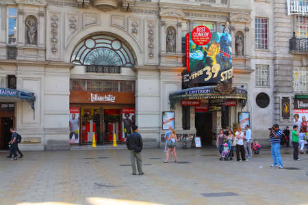 London, United Kingdom - June 5, 2010: A building in front of which there are people on the sidewalk. The shop window and the entrance to the theater, which are located in this building, are visible.のeditorial素材