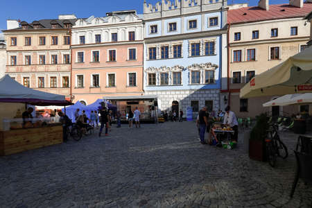 Lublin, Poland - September 10, 2021: Old town buildings with nearby outdoor market stalls located on...