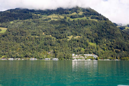 Apartment buildings located on the slope of the hill on the edge of Lake Lucerne are visible at a...