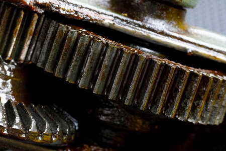 This is a view of the transmission mechanism from the crank to the chuck of an old hand drill. Worn...