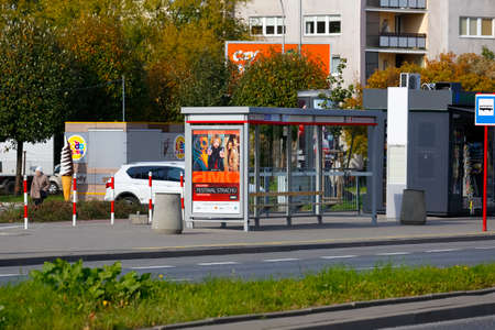Warsaw, Poland - October 6, 2021: The now empty bus stop is located on the city streets in the Goclaw estate. Apartment buildings and lots of trees are visible nearby.のeditorial素材