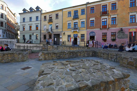 Lublin, Poland - September 10, 2021: Old town tenement houses with nearby paved walkway. There are people spending their time watching the area.のeditorial素材