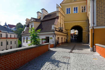 Lublin, Poland - September 11, 2021: The old town gate and the paved trail leading towards the old town. There is a small building next to the gate that houses a cafe.のeditorial素材