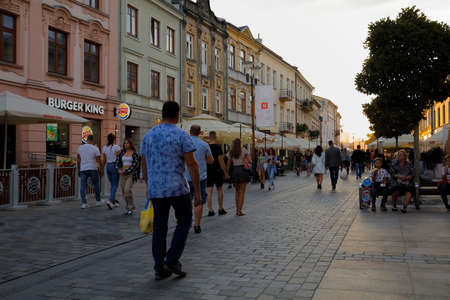 Lublin, Poland - September 10, 2021: At dusk, people walk along the wide promenade that runs between tenement houses.のeditorial素材