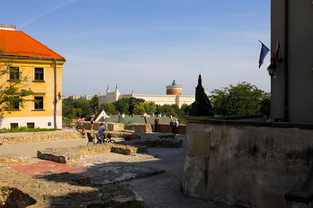 Lublin, Poland - September 11, 2021: Po Farze Square in the Old Town in the place of the currently non-existent Roman Catholic parish church. The Lublin Castle is seen in the distanceのeditorial素材
