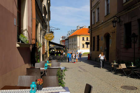 Lublin, Poland - September 11, 2021: One of the cobblestone streets of the old town with outdoor restaurants and cafes waiting for people to come inのeditorial素材