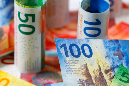 Swiss money. Several different Swiss franc notes have been placed next to each other and now form the background for financial matters. CHF currency.の写真素材