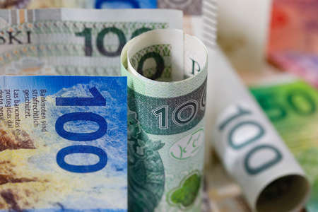 Swiss and Polish money. Banknotes of the Polish zloty and Swiss franc were placed next to each other and now constitute the background for many different financial matters. PLN and CHF currenciesの写真素材